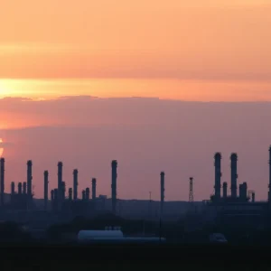 Industrial oil refinery landscape illustrating closure and environmental concerns